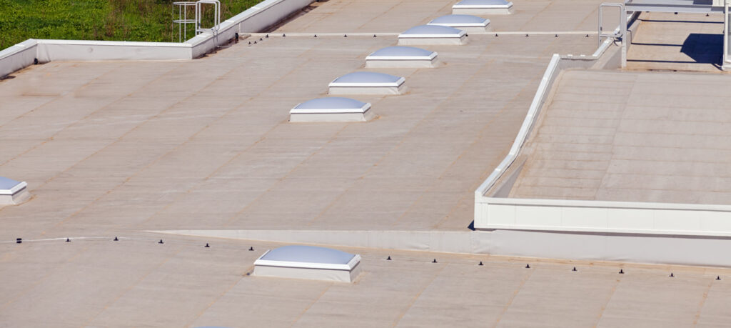 Industrial hall roof with large windows, showcasing roofing services Jacksonville FL expertise in modern design.